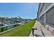 Backyard patio overlooking the canal and boat docks, complete with outdoor furniture at 521 Pinellas Bayway S # 104, St Petersburg, FL 33715