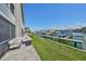 Backyard patio featuring outdoor furniture and views of the canal and boat docks at 521 Pinellas Bayway S # 104, St Petersburg, FL 33715