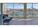 Screened-in balcony with outdoor seating and views of the waterway and boats at 521 Pinellas Bayway S # 104, St Petersburg, FL 33715