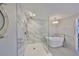 Elegant bathroom featuring a soaking tub, glass shower, and stylish fixtures at 521 Pinellas Bayway S # 104, St Petersburg, FL 33715