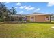 Spacious backyard featuring a screened-in pool with grass at 5327 N Cranberry Blvd, North Port, FL 34286