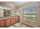 Well-lit bathroom with double sinks, granite countertops, and a large window for natural light at 5327 N Cranberry Blvd, North Port, FL 34286