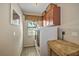 Functional laundry room with modern washer and dryer, overhead cabinets, and counter space at 5327 N Cranberry Blvd, North Port, FL 34286