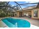 Stunning screened-in pool with a fountain feature and outdoor dining space at 5327 N Cranberry Blvd, North Port, FL 34286