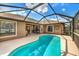 Inviting screened-in pool with tile trim and outdoor seating area at 5327 N Cranberry Blvd, North Port, FL 34286