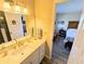 Bathroom featuring a single sink vanity with a white countertop and framed mirror at 5973 Terrace Park N Dr # 301, St Petersburg, FL 33709