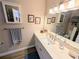 Bathroom featuring a single sink vanity, framed mirror, and overhead lighting at 5973 Terrace Park N Dr # 301, St Petersburg, FL 33709