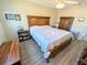 Bedroom featuring a full-size bed and wood furniture at 5973 Terrace Park N Dr # 301, St Petersburg, FL 33709