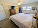 Spacious bedroom with a ceiling fan, a large window, and a dresser at 5973 Terrace Park N Dr # 301, St Petersburg, FL 33709