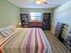 Bedroom featuring a bed, wood laminate flooring, and ceiling fan at 5973 Terrace Park N Dr # 301, St Petersburg, FL 33709