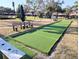 Community bocce ball court featuring artificial turf surface and bench seating for comfortable viewing at 5973 Terrace Park N Dr # 301, St Petersburg, FL 33709