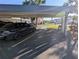 View of the covered carport, showing parking space and surrounding landscaping at 5973 Terrace Park N Dr # 301, St Petersburg, FL 33709