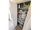 Linen closet with ample storage and shelving, neatly organized with household items at 5973 Terrace Park N Dr # 301, St Petersburg, FL 33709