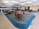 Community clubhouse featuring tables, chairs, and ample open space at 5973 Terrace Park N Dr # 301, St Petersburg, FL 33709