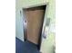 Elevator with wooden paneled door and stainless steel buttons at 5973 Terrace Park N Dr # 301, St Petersburg, FL 33709