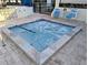 Inviting hot tub area with tiled surround and clear rules posted for safety at 5973 Terrace Park N Dr # 301, St Petersburg, FL 33709