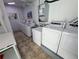 Community laundry room featuring multiple modern washers and dryers at 5973 Terrace Park N Dr # 301, St Petersburg, FL 33709