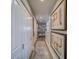 Hallway leading to living area with decorative art pieces and storage at 6 Belleview Blvd # 203, Belleair, FL 33756