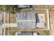 A high-angle aerial view showcases the house's roof, full fenced-in yard, driveway and proximity to the road at 6303 Central Ave, New Port Richey, FL 34653