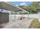 Covered patio with picnic table and storage shed in a fenced backyard at 6303 Central Ave, New Port Richey, FL 34653