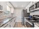 Modern kitchen featuring granite countertops, stainless steel appliances, and ample cabinet space at 6303 Central Ave, New Port Richey, FL 34653