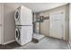 Utility room with stacked washer and dryer, water heater and door at 6303 Central Ave, New Port Richey, FL 34653