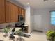 A well-lit kitchen featuring light wood cabinetry, stainless steel appliances, and tiled flooring at 6400 Falcon Lair Dr, North Port, FL 34287