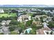 Aerial view of the community showcasing mature trees, a golf course, and a scenic lake at 700 Starkey Rd # 914, Largo, FL 33771