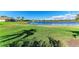 Manicured lawn extends to the edge of a tranquil lake, framed by clear skies at 7115 Marsh View Ter, Bradenton, FL 34212