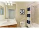 Bathroom featuring a shower, tub, toilet and a light colored wall at 7115 Marsh View Ter, Bradenton, FL 34212