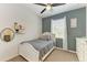 Cozy bedroom with a gray accent wall, dresser, ceiling fan, and carpeted floors at 7115 Marsh View Ter, Bradenton, FL 34212