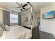 Light filled bedroom featuring a television and a large window at 7115 Marsh View Ter, Bradenton, FL 34212