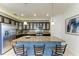 Spacious kitchen island with seating and pendant lighting, dark wood cabinets and stainless steel appliances at 7115 Marsh View Ter, Bradenton, FL 34212