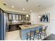 Spacious kitchen island with seating and pendant lighting, dark wood cabinets and stainless steel appliances at 7115 Marsh View Ter, Bradenton, FL 34212