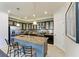 Spacious kitchen island with seating and pendant lighting, dark wood cabinets and stainless steel appliances at 7115 Marsh View Ter, Bradenton, FL 34212