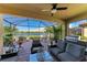 Covered patio with a ceiling fan, a grill, outdoor seating, and water views at 7115 Marsh View Ter, Bradenton, FL 34212