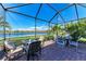 Screened patio with outdoor seating, tables, and gorgeous views of the lake at 7115 Marsh View Ter, Bradenton, FL 34212