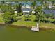 Aerial view of property with a private dock on a serene lake at 7609 Clair Wood Ct, Apollo Beach, FL 33572