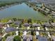 Aerial view of home with lake in the background, nestled in a desirable neighborhood at 7609 Clair Wood Ct, Apollo Beach, FL 33572