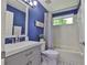 Cozy bathroom with blue walls, white fixtures, and a shower-tub combo at 7609 Clair Wood Ct, Apollo Beach, FL 33572