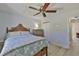 Bedroom features a ceiling fan, wooden bed frame, light walls, and wood-look floors at 7609 Clair Wood Ct, Apollo Beach, FL 33572