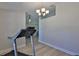 Bonus room features a chandelier, light-colored walls, and light wood-look floors at 7609 Clair Wood Ct, Apollo Beach, FL 33572