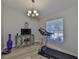 A bonus room featuring a chandelier and a treadmill at 7609 Clair Wood Ct, Apollo Beach, FL 33572