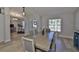 Dining room with an eye-catching center table, natural light, and stylish decor at 7609 Clair Wood Ct, Apollo Beach, FL 33572