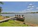 Waterfront dock with chairs, offering stunning views and tranquil relaxation by the water at 7609 Clair Wood Ct, Apollo Beach, FL 33572