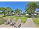 Waterfront living with private dock featuring Adirondack chairs overlooking lush landscaping at 7609 Clair Wood Ct, Apollo Beach, FL 33572