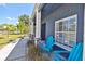 Inviting front porch featuring a seating area, decorative columns, and shade at 7609 Clair Wood Ct, Apollo Beach, FL 33572