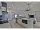 Contemporary open kitchen with white cabinetry, stainless steel appliances, and breakfast bar with seating at 7609 Clair Wood Ct, Apollo Beach, FL 33572