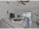 Comfortable living room with sliding glass doors to screened in porch overlooking the water at 7609 Clair Wood Ct, Apollo Beach, FL 33572