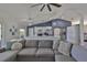 Spacious living room flows into a modern kitchen with seating and an inviting and cohesive living space at 7609 Clair Wood Ct, Apollo Beach, FL 33572